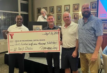 A group of people holding a large cheque for $270,000