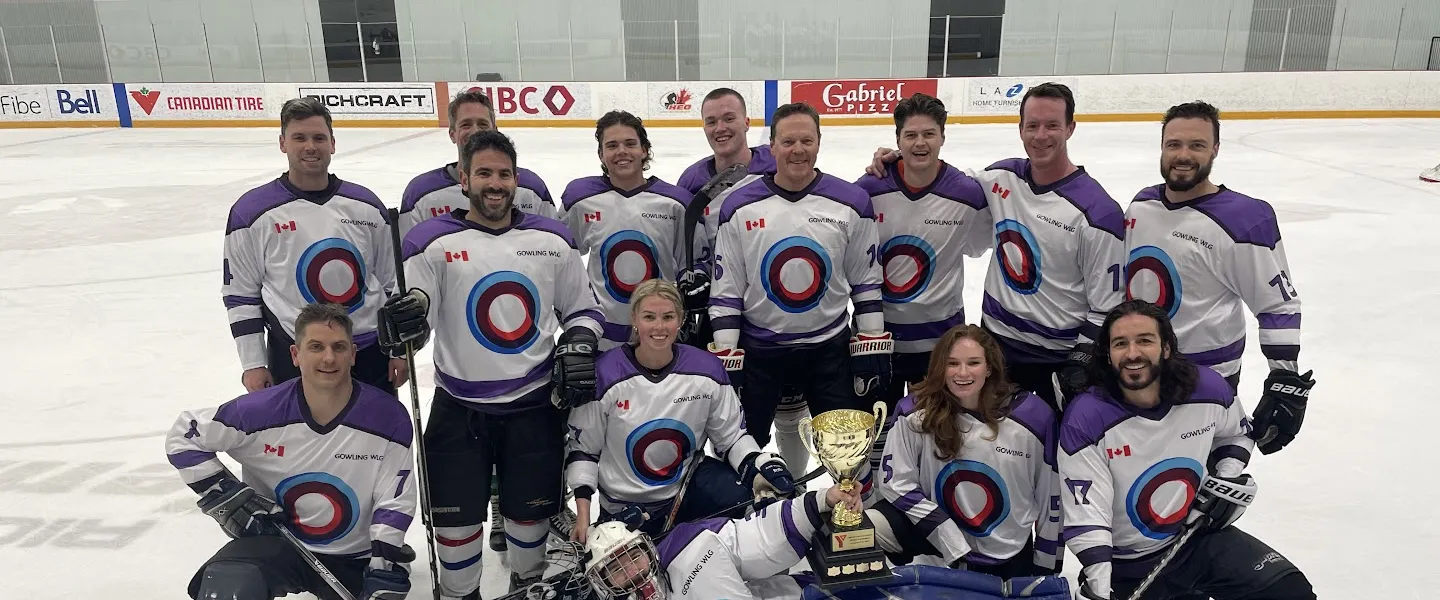 Gowling WLG staff in their hockey gear on the ice rink