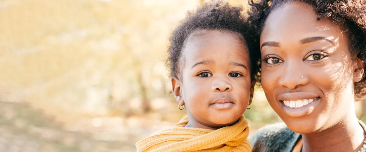 A woman poses with her child.