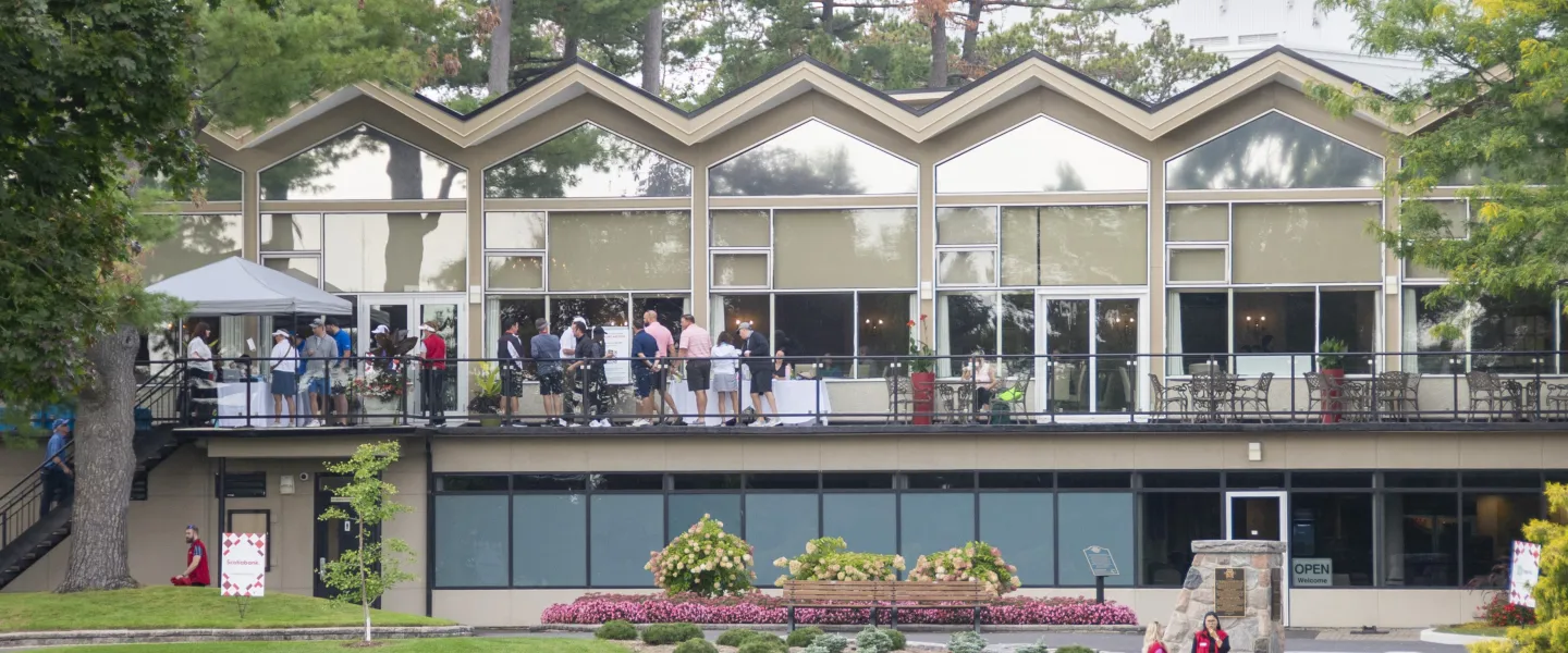 People on the terrace of a golf club building