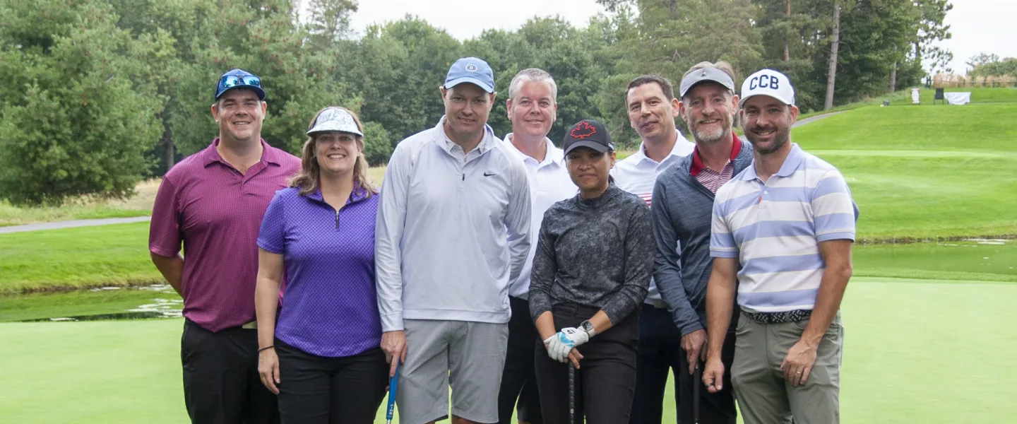 A group photo of eight golfers