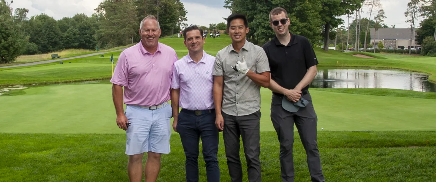 A group photo of four golfers