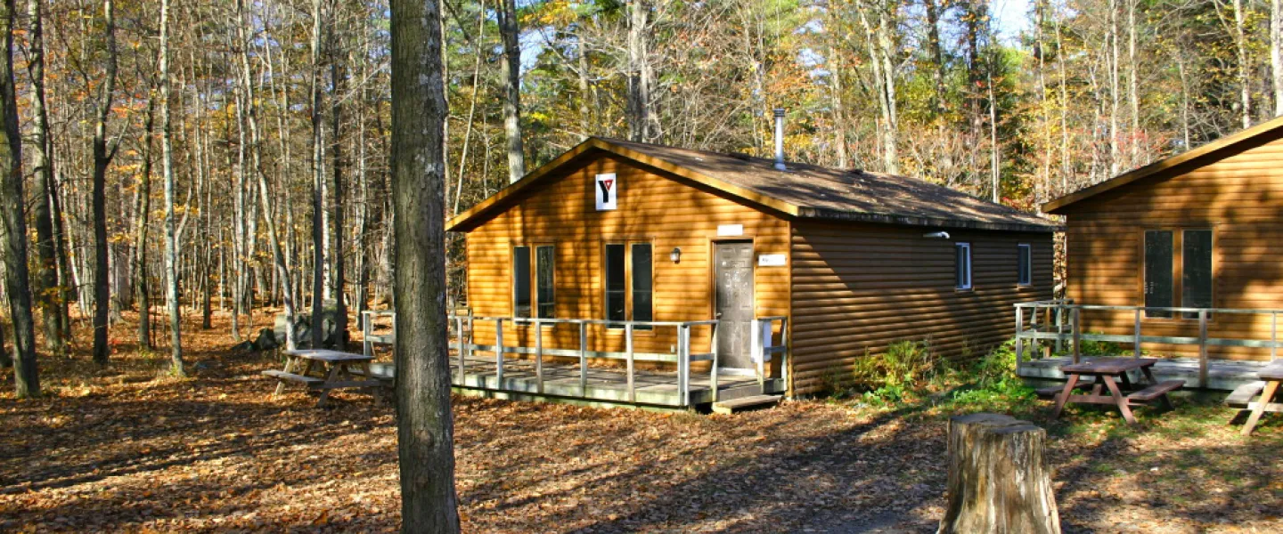 A cabin nestled amongst trees.