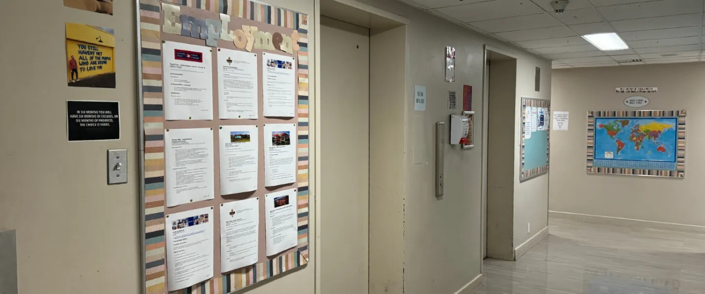 Second Stage Housing hallway with elevators and an employment board