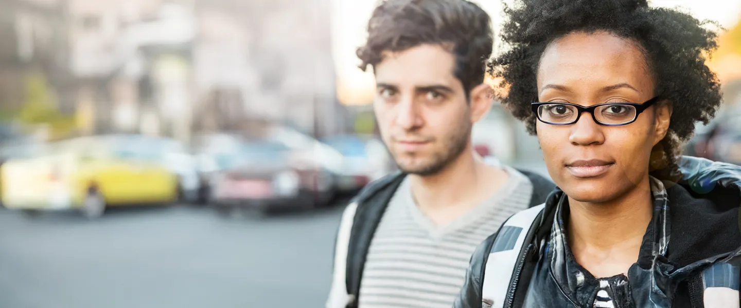 Man and woman outdoors on street.