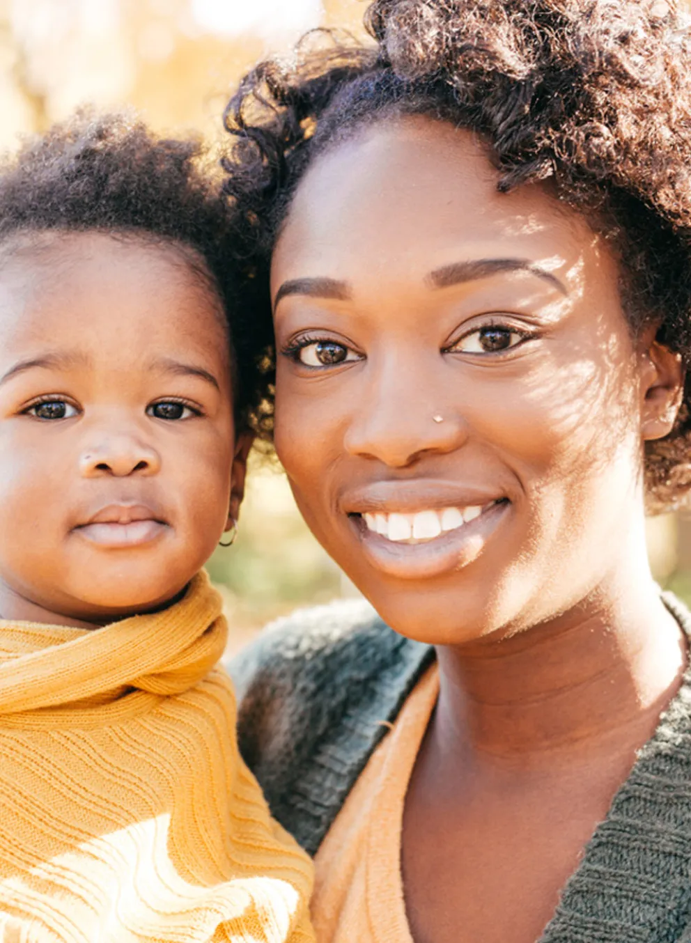 A woman poses with her child.