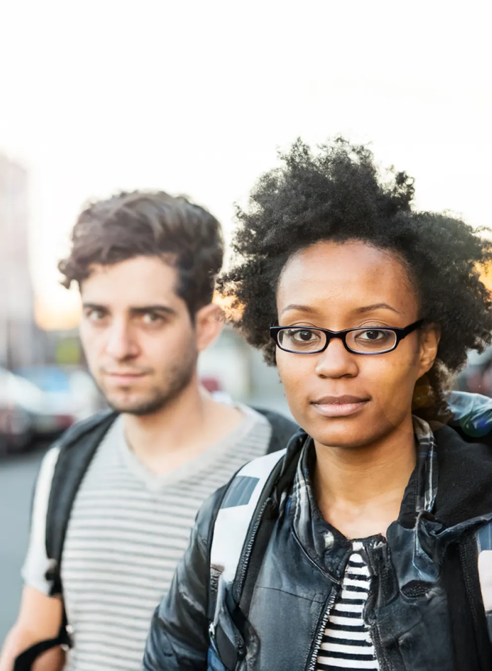 Man and woman outdoors on street.