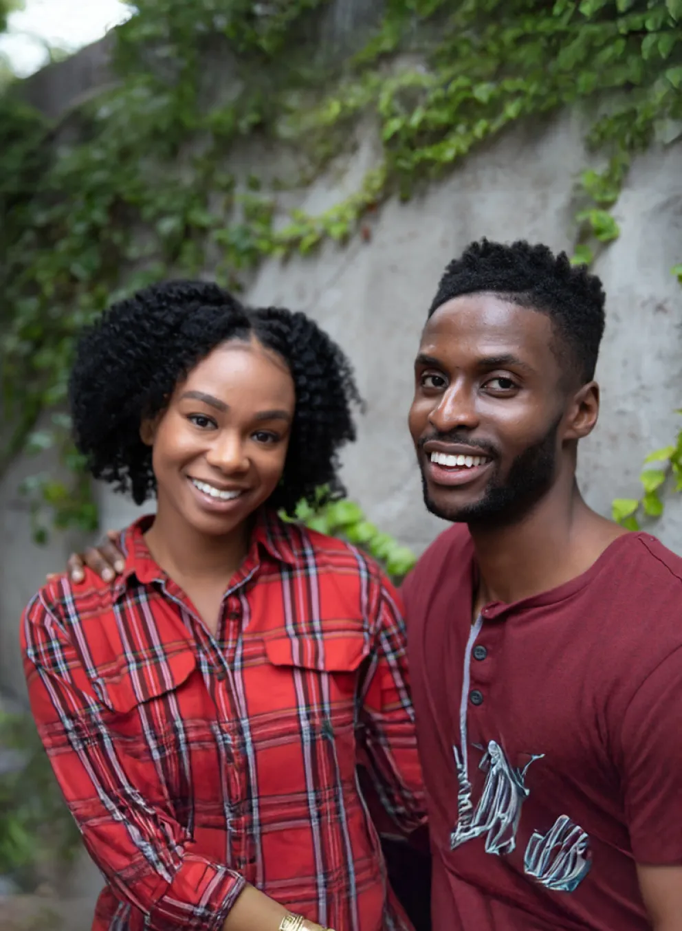 man and woman outdoors smile at camera