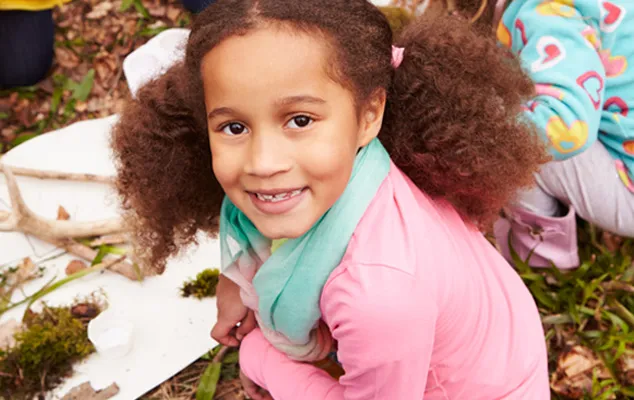 A girl smiles at the camera.