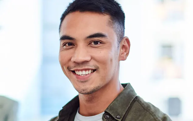 A confident smiling, confident young man participates in a business meeting.